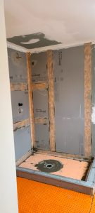 Illustration of an unfinished bathroom renovation with a shower under construction