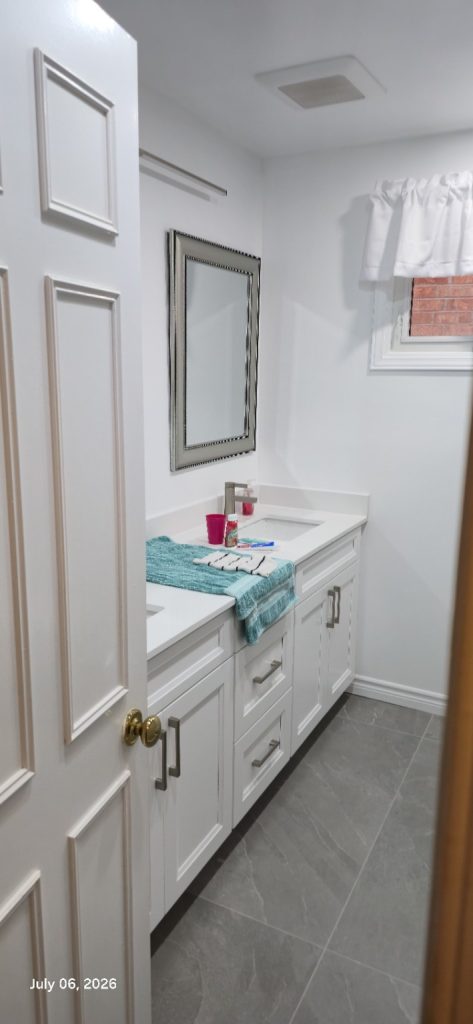 Completed bathroom with white double vanity and grey floor tile