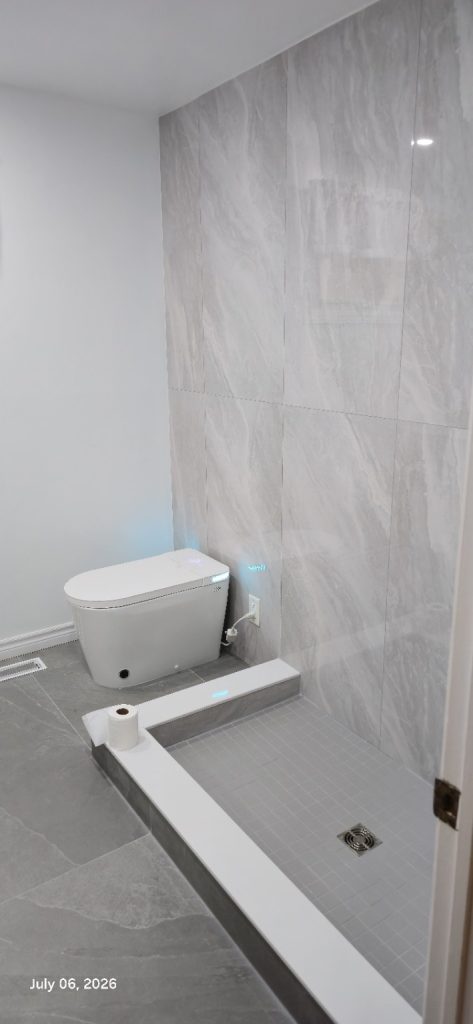 Completed bathroom by A&R Renovations with a tiled walk-in shower